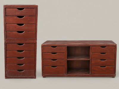 two wooden drawers and a cabinet with drawers on each side