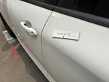 a sticker on the door of a white car