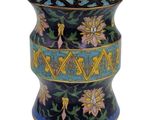 a blue vase with a design on it on a white background