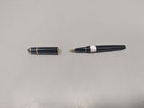two pens that are laying next to each other on a table