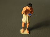 a small figurine of a man holding a frisbee
