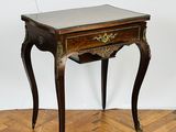 an image of a wooden table with a marble top on a parquet floor