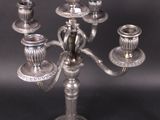 a silver candelab that has five candles on it