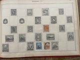 an open book with stamps on it sitting on a table