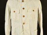 an old white jacket on a mannequin stand against a black background