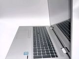 a silver laptop with a blue sticker on the screen