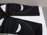 a pair of black and white pants laying on a table