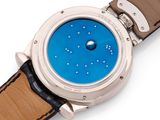 a close up of a wrist watch with a blue dial