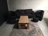 a living room with a couch, chair, coffee table and a rug
