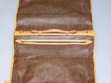 an old suitcase with a handle and two zippers on top of it