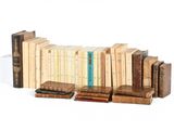 a lot of books that are stacked on top of each other
