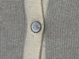 a close up of a button on a sweater
