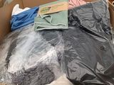 a cardboard box full of clothes and other items in it