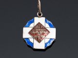 a silver and enamel medal with a blue and white cross on it