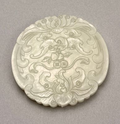 a white plate with a design on it on a table