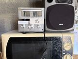 two microwaves and a radio on top of each other