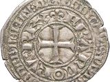 an old silver coin with a cross on it