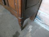 a wooden cabinet with a drawer on top of it