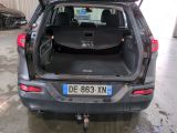 the back end of a car with the trunk open in a garage