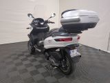 a motorcycle parked in a room with a black and white checkered floor