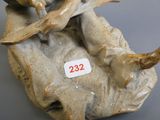 une figurine représentant un homme assis sur le dos d'une vache