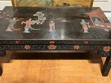 an image of a black table with a painting on it