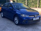 a blue volkswagen e - golf parked in a parking lot