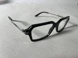 a pair of glasses sitting on a white surface
