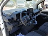the interior of a small car with a steering wheel and dashboard