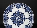 a blue and white plate with a floral design on it