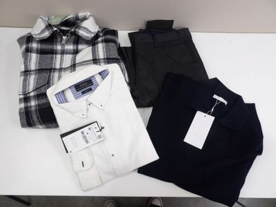 three men ' s shirts and pants are laid out on a table