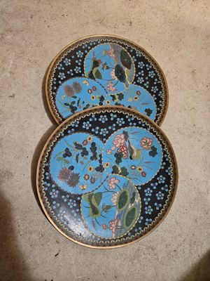 three decorative plates are sitting on the floor next to each other