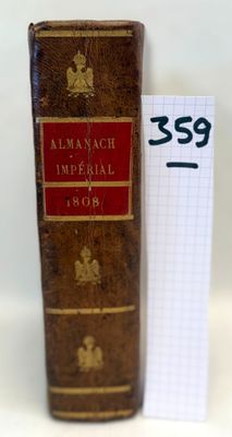 an old book sitting on top of a table next to a piece of paper