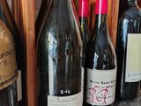several bottles of wine are lined up on a counter