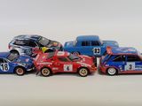 several toy cars are lined up in a row on a white surface