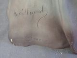 a silver vase with writing on it sitting on a table