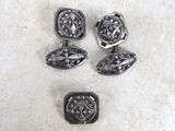 three pairs of silver cufflinks with a flower design