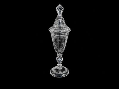 an image of a clear glass vase with a lid on a black background