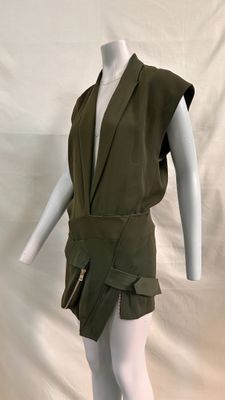 an image of a mannequin wearing a green dress and white tights