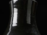 a black vase that is sitting on a table