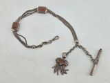 a silver bracelet with a cross and charms on it