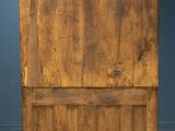 an old wooden cabinet with a door on top of it