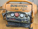 an old air compressor sitting on top of a wooden floor