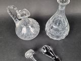 two clear glass vases sitting next to each other on a table