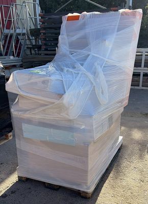 a pile of boxes sitting on top of a pallet in front of a truck