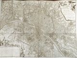 an old map of a city on display on a table