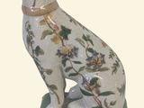 a figurine of a dog sitting on top of a table