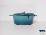 a blue casserole with a lid sitting on a table