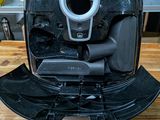 a black and silver air fryer sitting on a wooden table