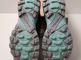 the soles of a pair of hiking shoes on a white surface